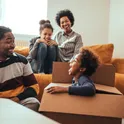 A family unpacking boxes in a new living room